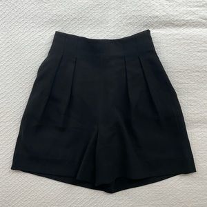 Aritzia Babaton high-waisted black dress shorts.
